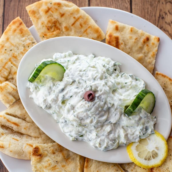 Fotia Greek Taverna's tzatziki dip with cucumber, olive, and lemon, served with pita bread.