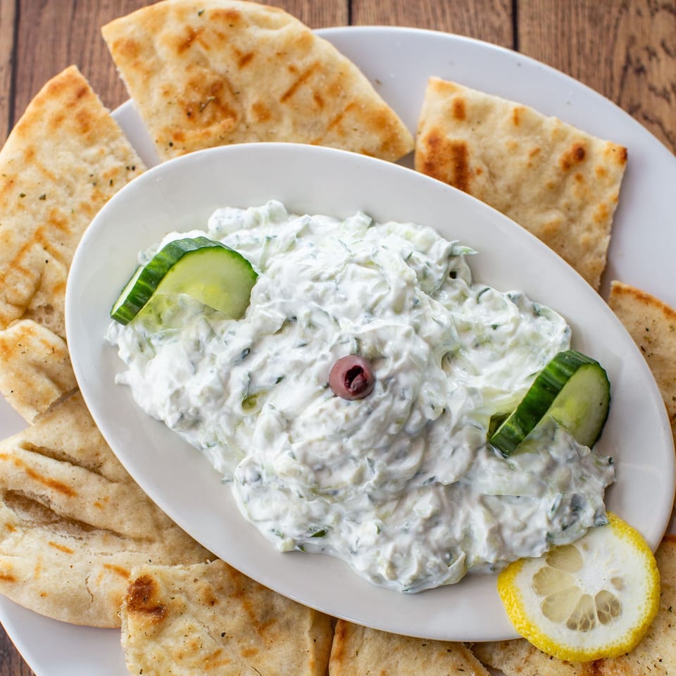 Fotia Greek Taverna's tzatziki dip with cucumber, olive, and lemon, served with pita bread.